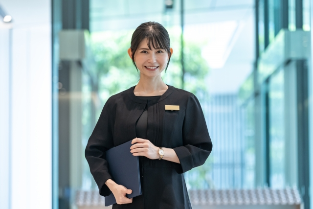 japanese staff dressed in black at a hotel 